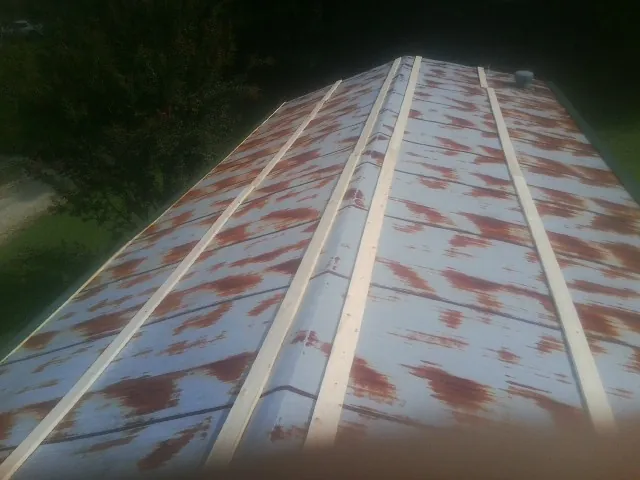 Rusted metal roof panels with new wood purlins before replacement — Storm Damage Roof Repair in Rio by Roofing Brothers