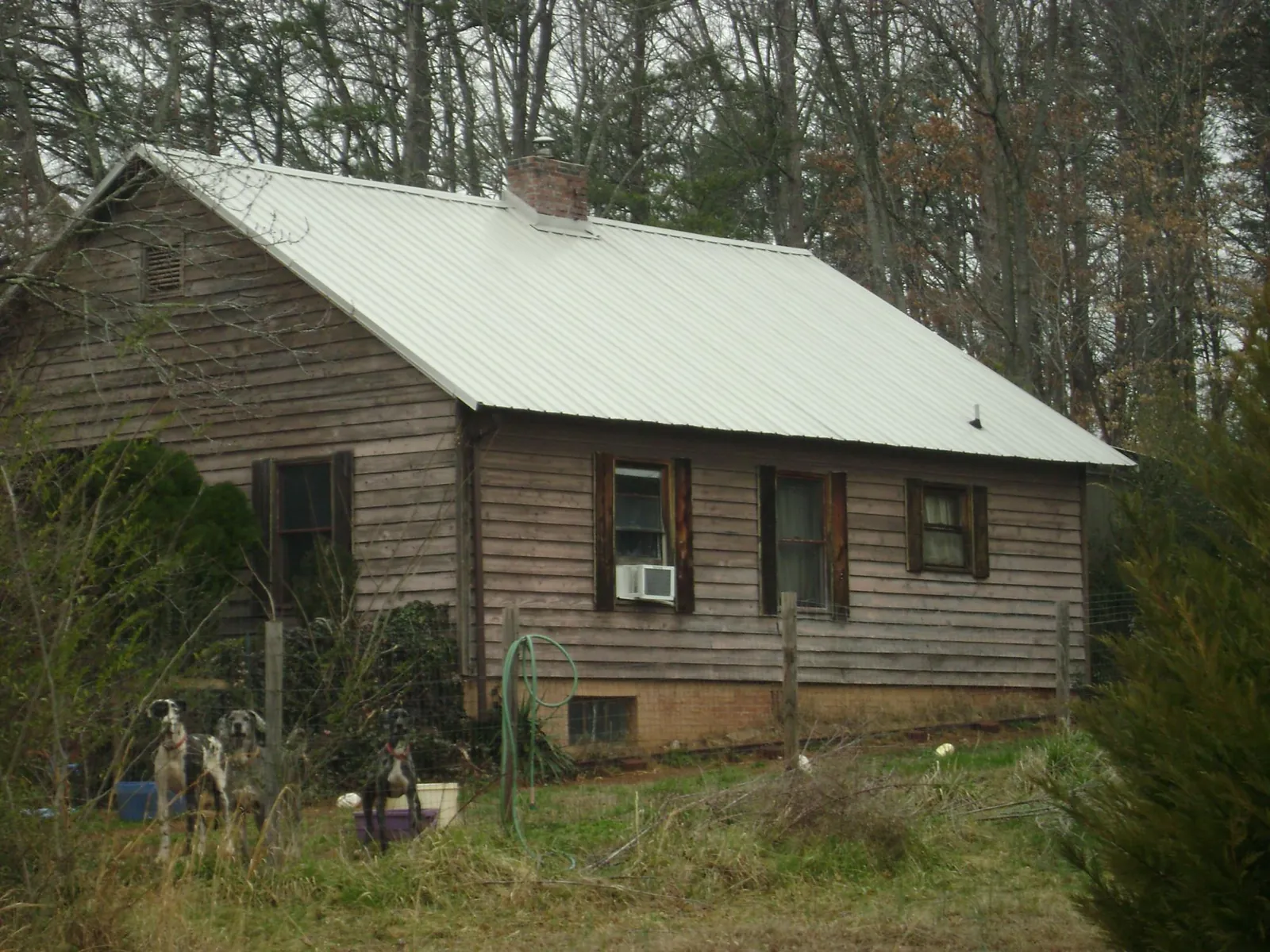 White metal roof on an old wood sided farmhouse, from a Metal Roof Installation job in Rio